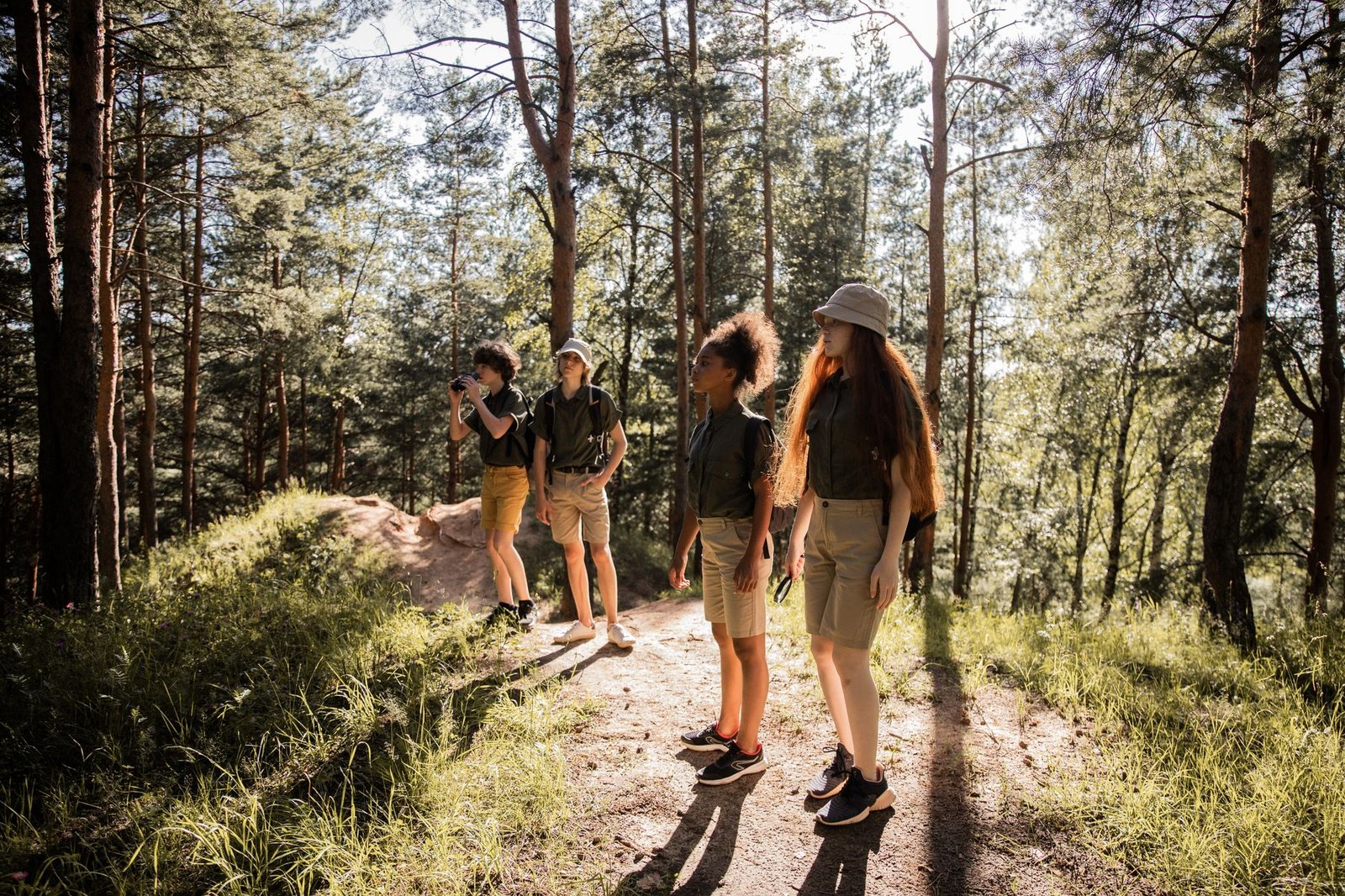 Teenagers enjoying a scouting adventure on a sunlit forest trail in summer. — Annapurna Base Camp vs. Everest Base Camp: Whic
