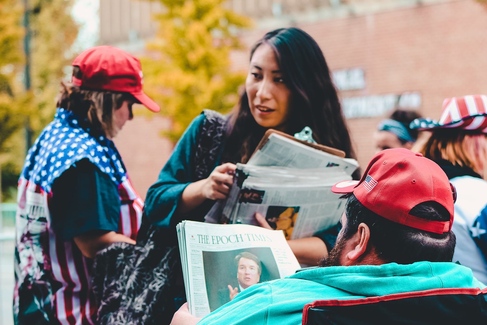 A group of adults reading newspapers outdoors, immersed in political discussions on a vibrant day. — Guide to Safe Access Met