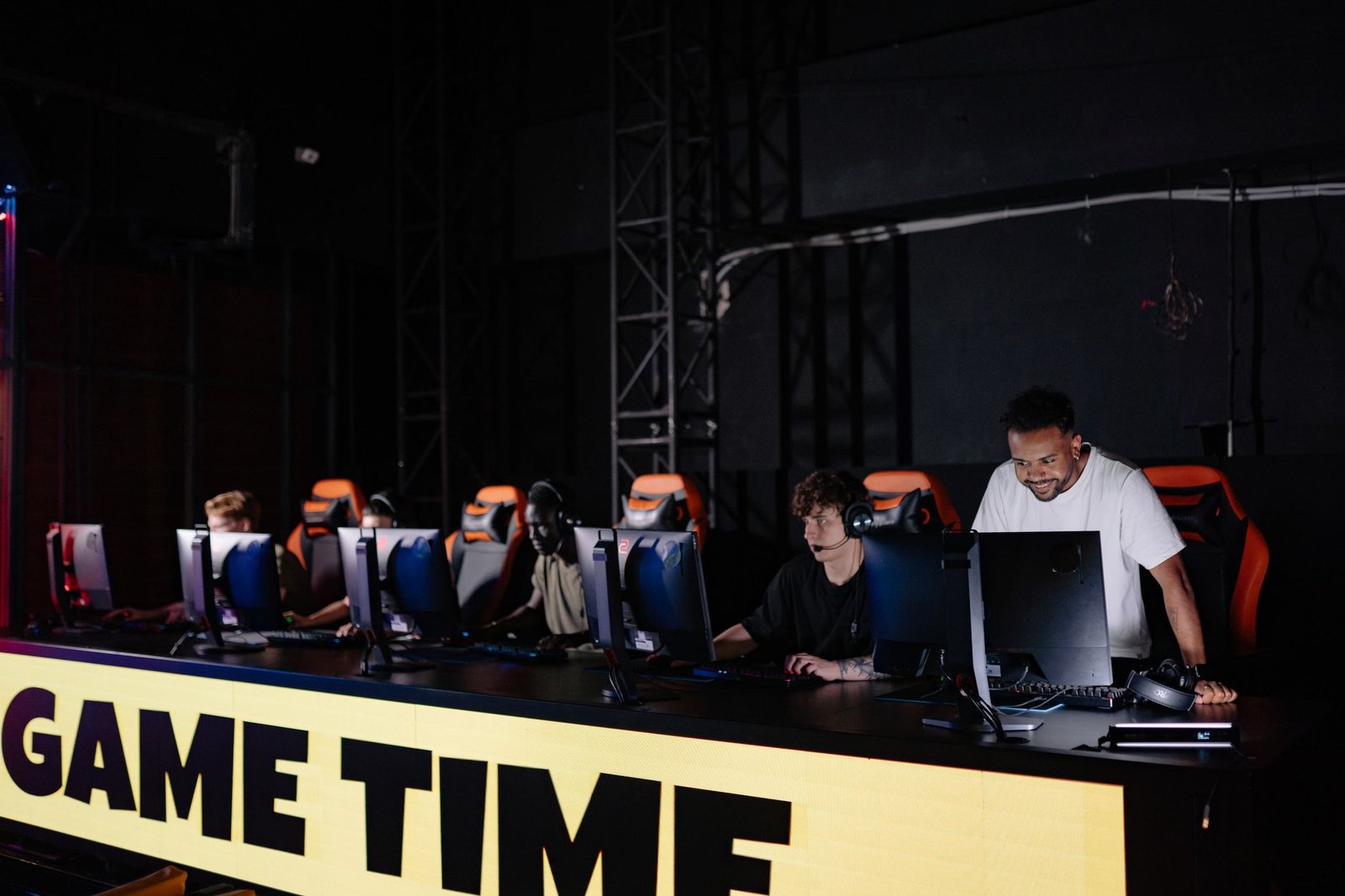 Esports team engaged in competitive gaming session indoors, showcasing teamwork and concentration. — How Toto TV Helps Player
