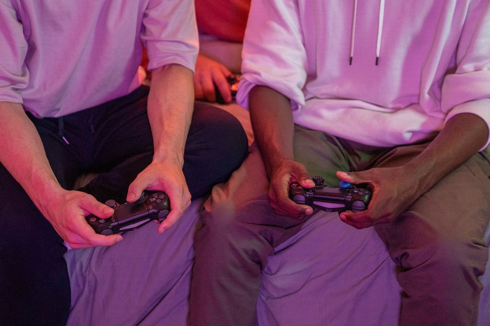 Two friends playing video games together at home, using controllers. — Step-by-step Fun88 registration for accessing bonuses,